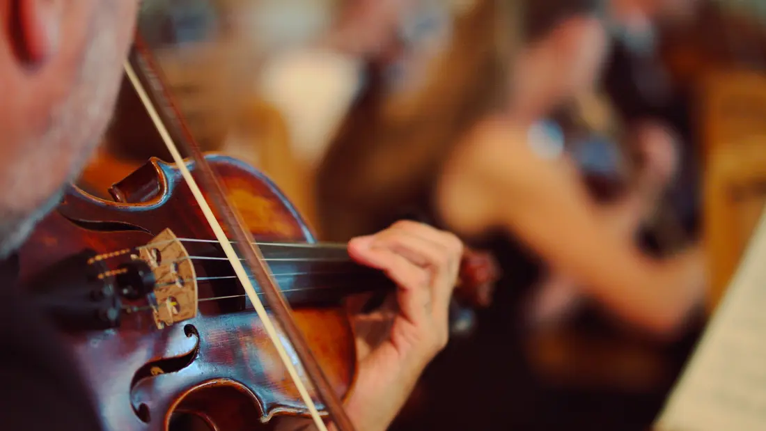 A chamber orchestra violinist, close-up